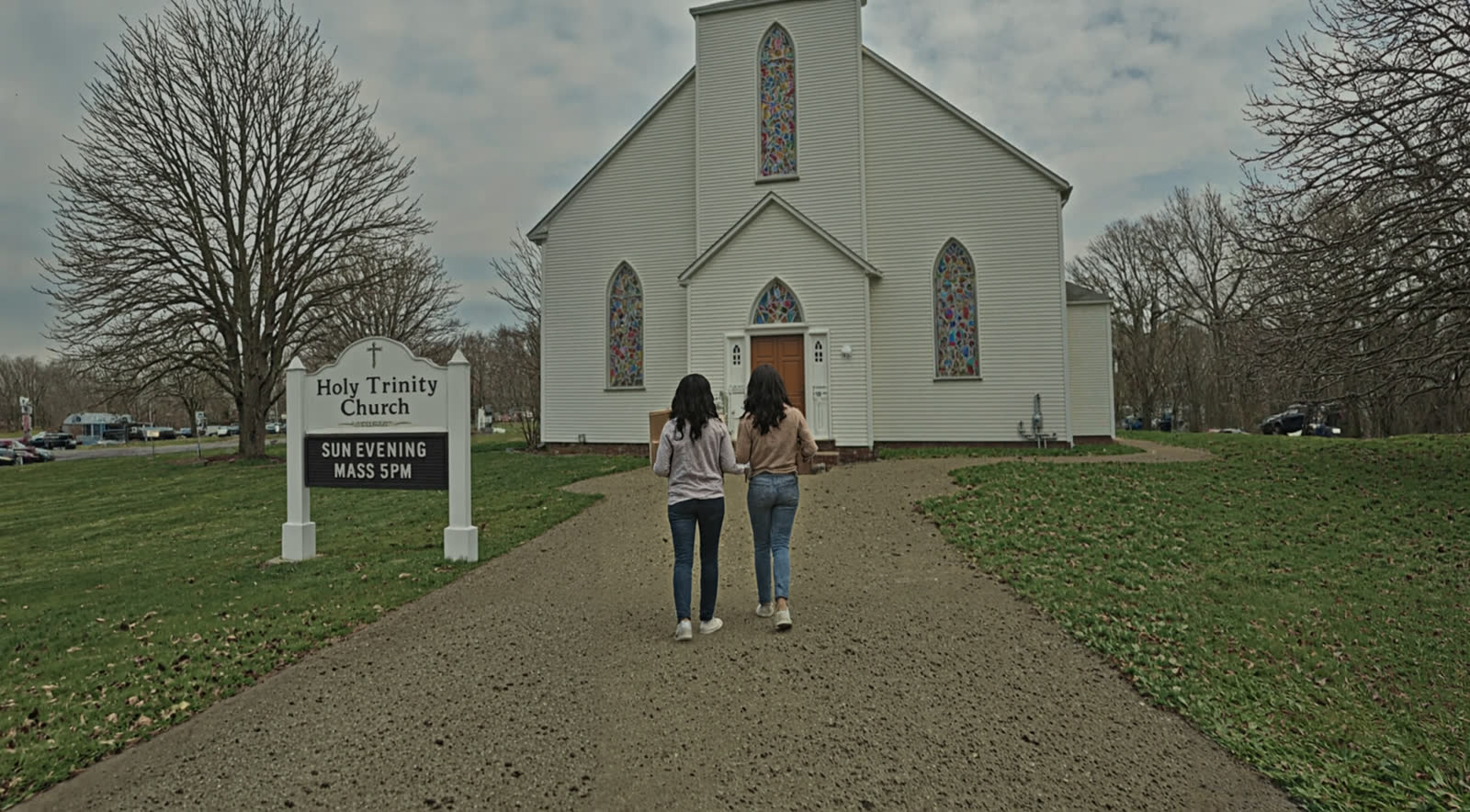 SAM and MOM walking toward Holy Trinity Church, shot from behind